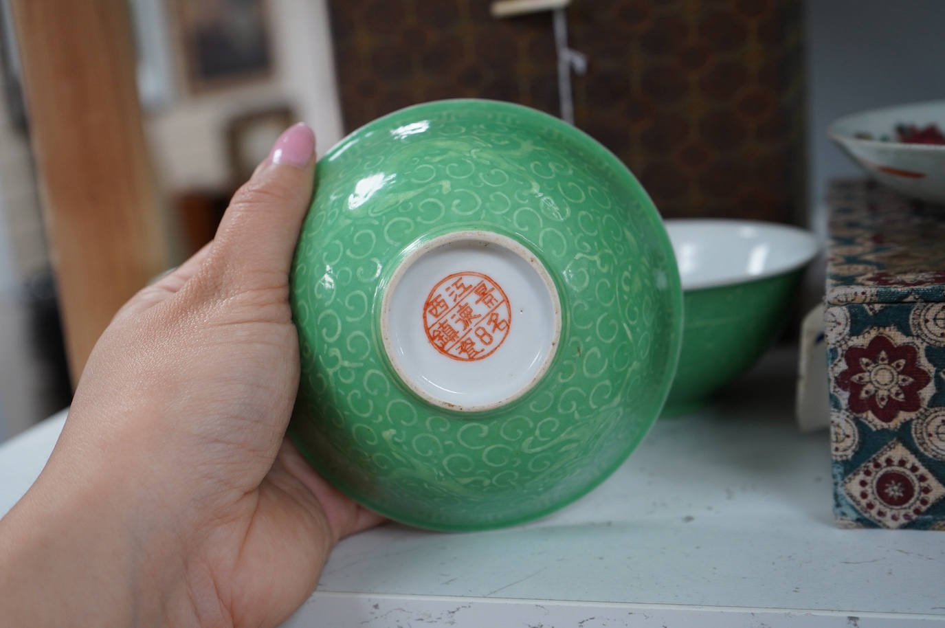 A set of four Chinese green glazed and moulded bowls and a famille rose dish, 19th and 20th century, boxed, largest 17cm. Condition - one bowl cracked